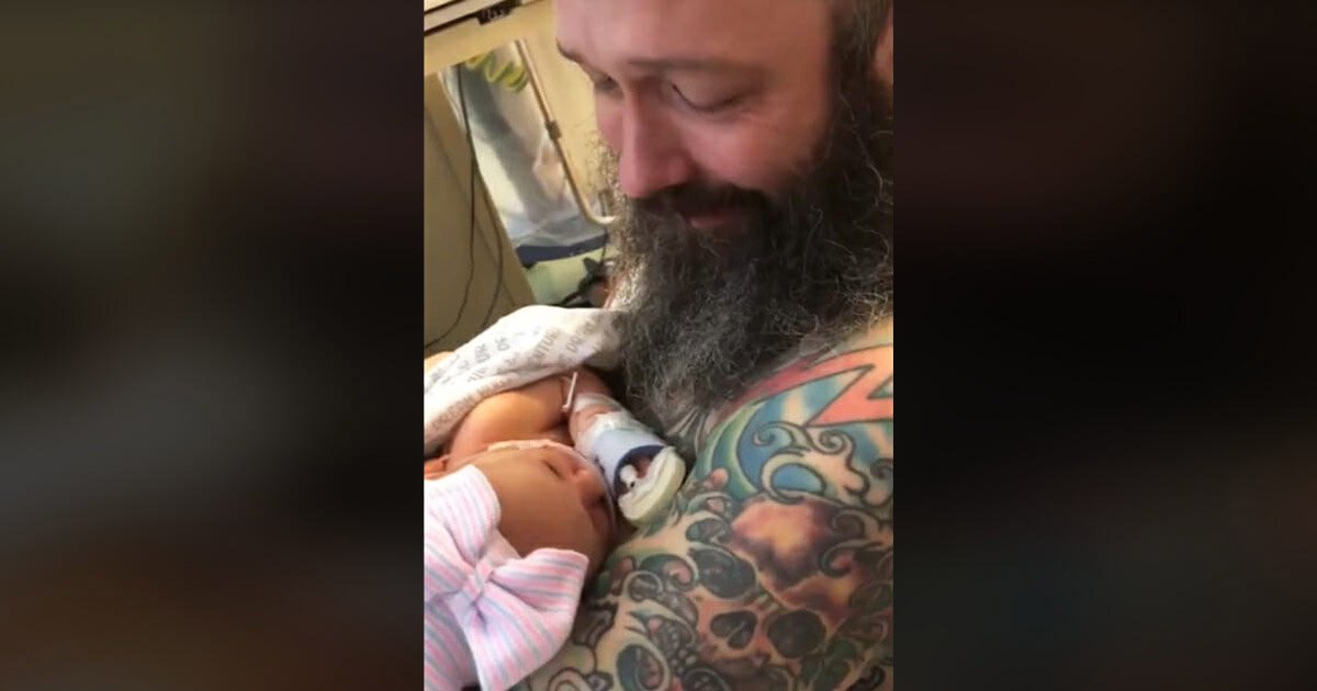 new-dad-cries-holding-baby