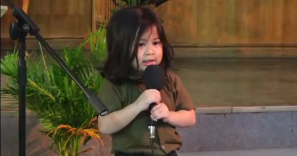 little boy singing because he lives