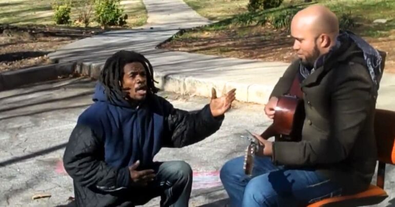 homeless man singing with carlos whittaker