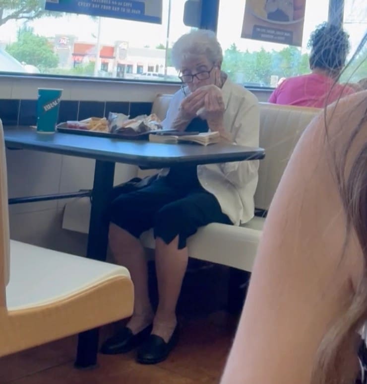 elderly woman eating alone