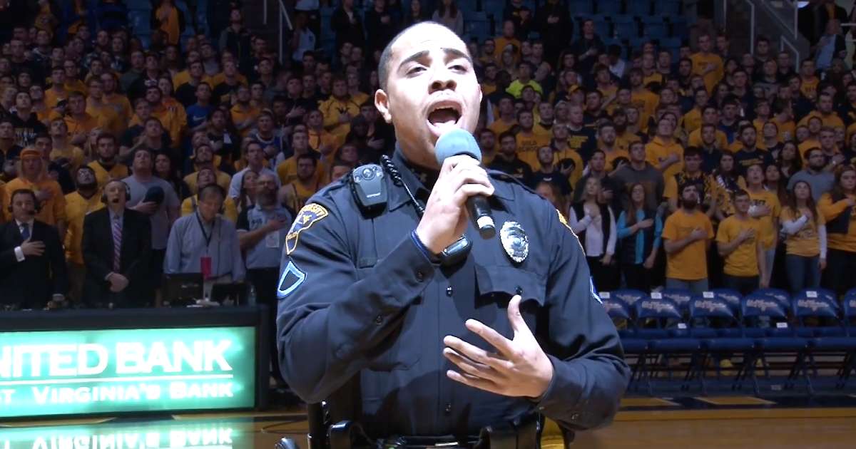 police officer singing national anthem