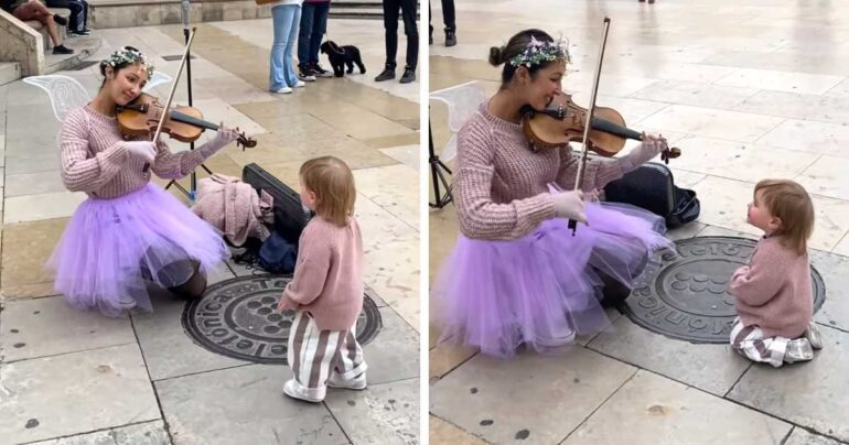 little girl watching violinist