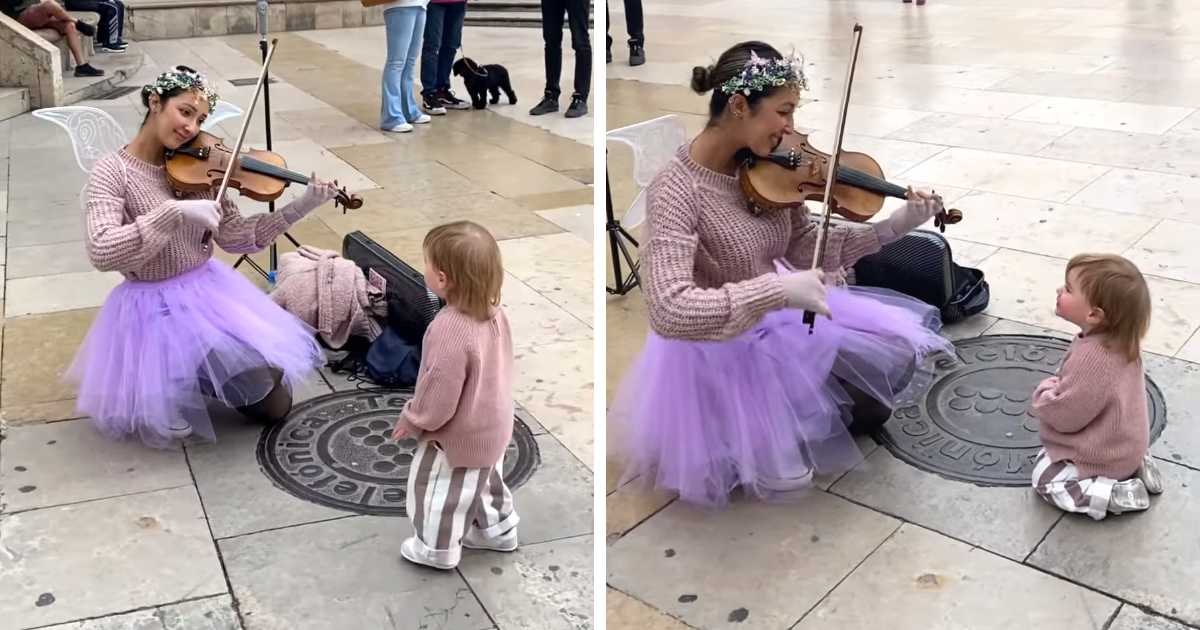 little girl watching violinist